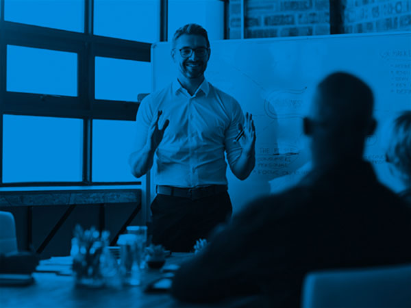 man speaking at whiteboard